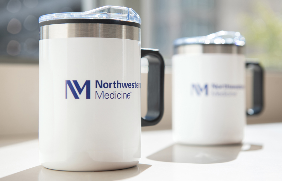 Travel coffee mugs with the Northwestern Medicine logo at the Northwestern Medicine brand store by Cloverkey