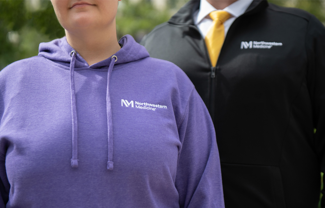 Hospital staff wearing Northwestern Medicine logowear sweatshirts and jackets