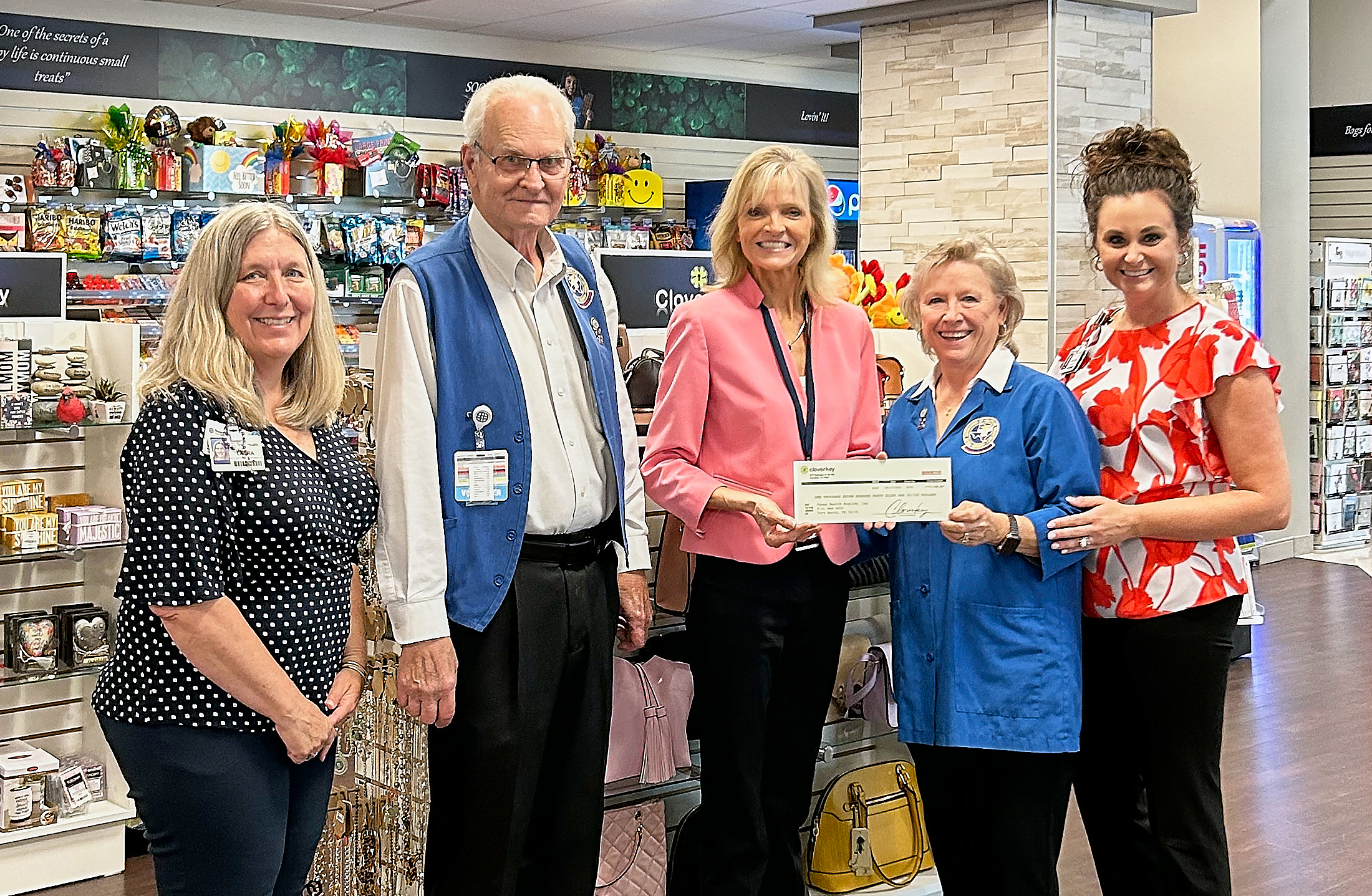Cloverkey's Chief Revenue Officer presents a commission check to volunteers at the Texas Health Huguley gift shop