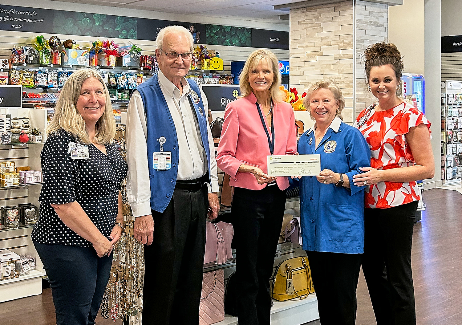 Kim Schuler, Chief Revenue Officer of Cloverkey, presents Texas Health Huguley volunteers a commission check.
